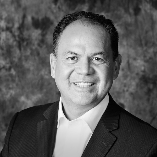 Image of man from chest up standing while looking at camera. he is Maro Vargas - Real Estate Agent at Loanplex Mortgage