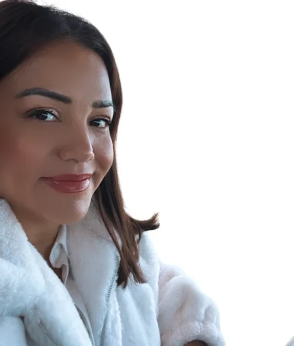 Image of woman from chest up standing while looking at camera. She is Image of woman from waist up standing while looking at camera. She is Yesica Gonzalez - Real Estate Agent